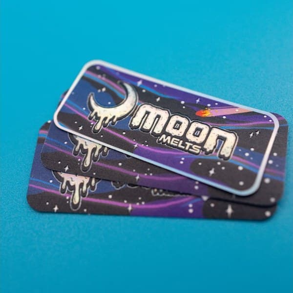 A stack of rectangular printed stickers on a blue background