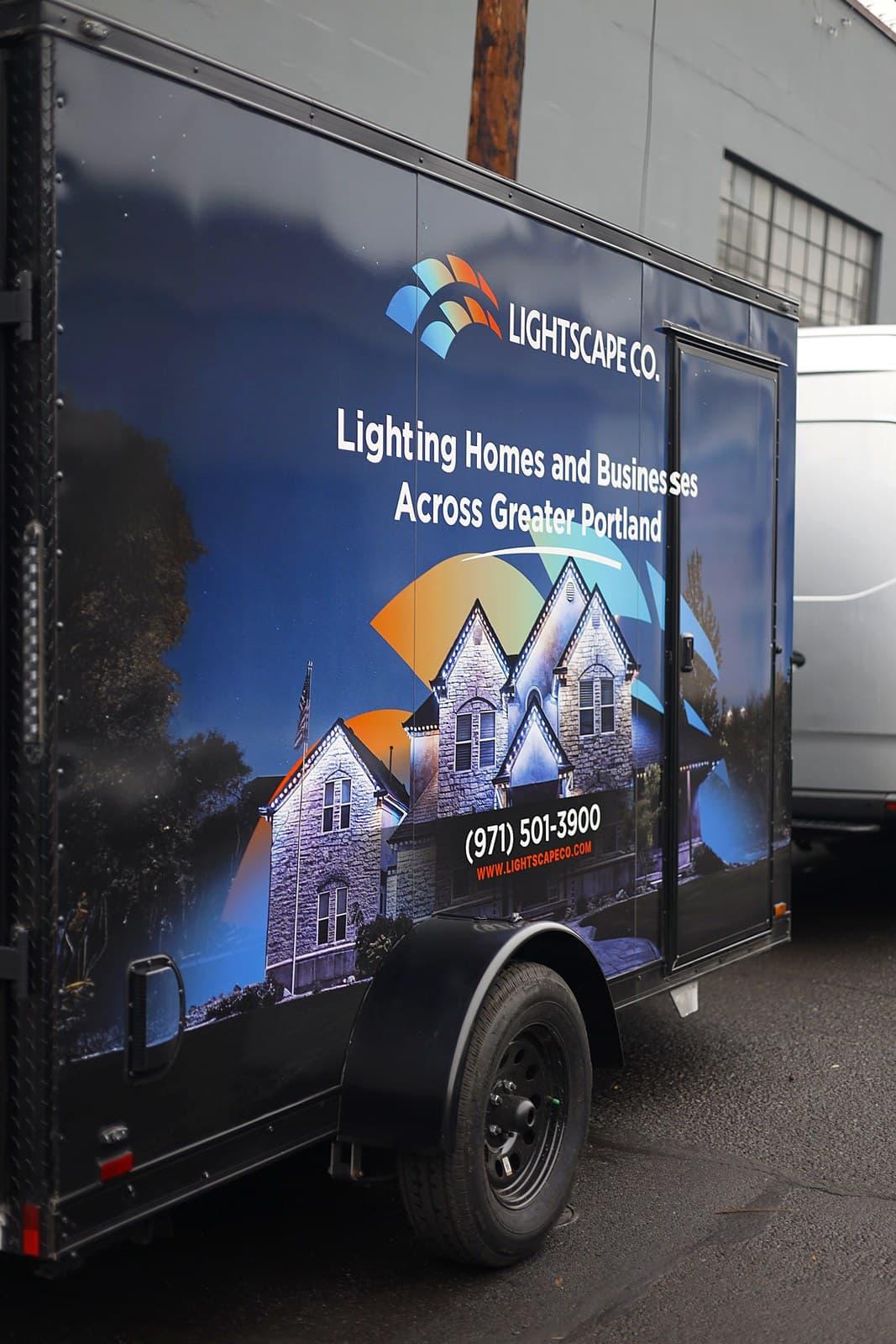 The same trailer wrap seen along its side, close enough to read the lettering